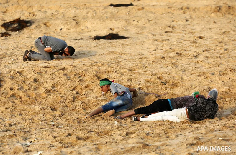 Palestinian protesters gather during clashes with Israeli forces in a demonstration against the Israeli blockade on Gaza Strip, along the Gaza sea barrier on the maritime border with Israel near Kibbutz Zikim, north of B...