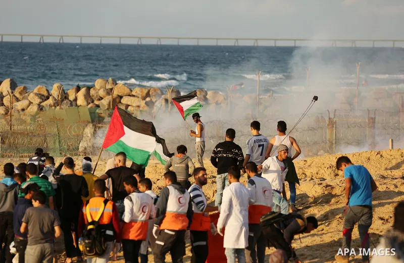 Palestinian protesters gather during clashes with Israeli forces in a demonstration against the Israeli blockade on Gaza Strip, along the Gaza sea barrier on the maritime border with Israel near Kibbutz Zikim, north of B...