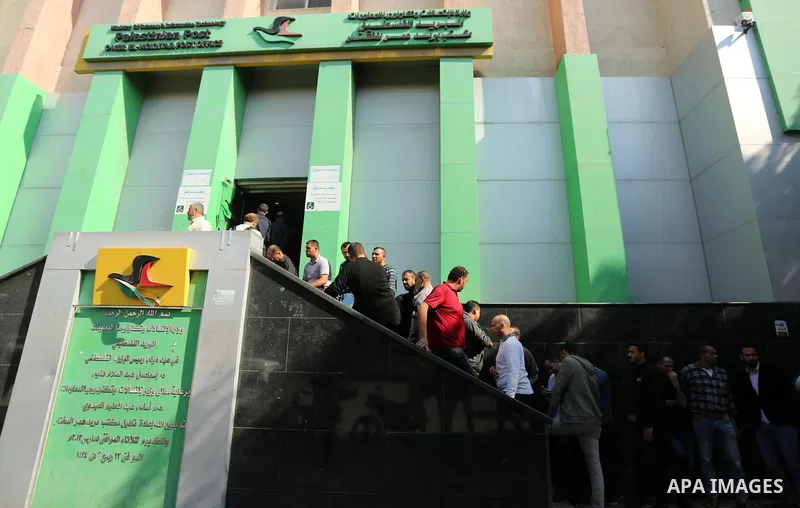 Palestinian employees of Gaza strip wait to receive their salaries at a Post Office, in Gaza city, on November 7, 2018. Palestinian Finance Ministry in Gaza Strip announced that the Ministry will pay officials 60 percent...