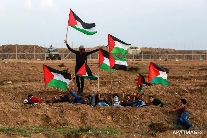 Palestinian protesters gather during clashes with Israeli troops in tents protest where Palestinians demand the right to return to their homeland at the Israel-Gaza border, in east of Gaza City on November 9, 2018. Photo...
