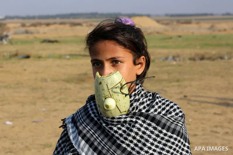 Palestinian protesters gather during clashes with Israeli troops in tents protest where Palestinians demand the right to return to their homeland at the Israel-Gaza border, in Khan Younis in the southern Gaza Strip on No...