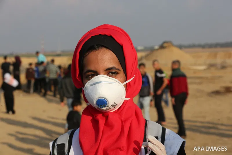 Palestinian protesters gather during clashes with Israeli troops in tents protest where Palestinians demand the right to return to their homeland at the Israel-Gaza border, in Khan Younis in the southern Gaza Strip on No...