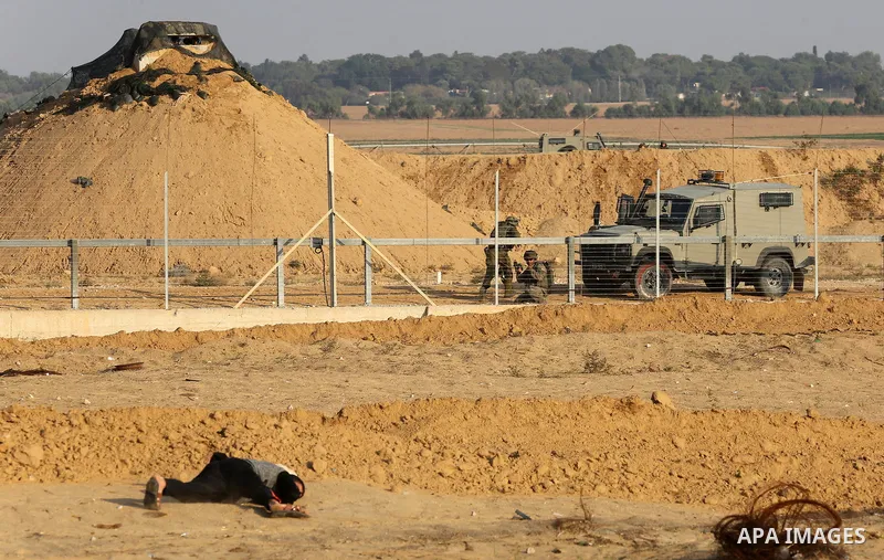 Palestinian protesters gather during clashes with Israeli troops in tents protest where Palestinians demand the right to return to their homeland at the Israel-Gaza border, in Khan Younis in the southern Gaza Strip on No...