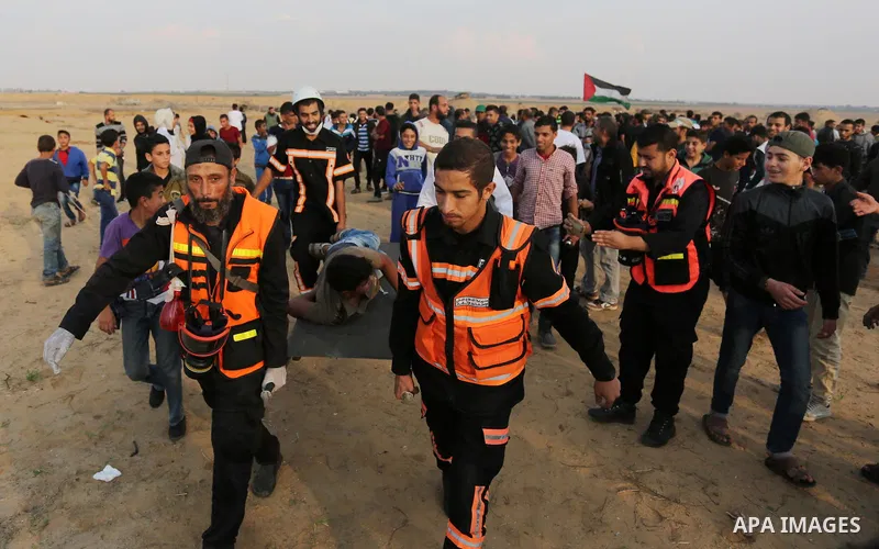 Palestinian protesters gather during clashes with Israeli troops in tents protest where Palestinians demand the right to return to their homeland at the Israel-Gaza border, in Khan Younis in the southern Gaza Strip on No...
