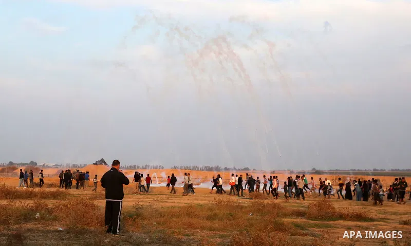Palestinian protesters gather during clashes with Israeli troops in tents protest where Palestinians demand the right to return to their homeland at the Israel-Gaza border, in Khan Younis in the southern Gaza Strip on No...