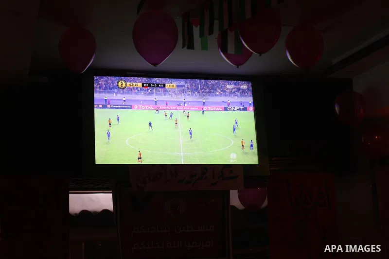 Palestinian fans watch the CAF Champions League second leg final football match between Egypt's Al-Ahly and Tunisia's ES Tunis which held on the Olympic stadium in Rades on a screen, in Gaza City on November 9, 2018. Pho...