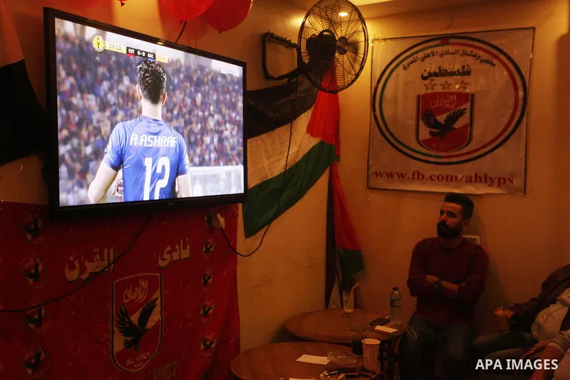 Palestinian fans watch the CAF Champions League second leg final football match between Egypt's Al-Ahly and Tunisia's ES Tunis which held on the Olympic stadium in Rades on a screen, in Gaza City on November 9, 2018. Pho...