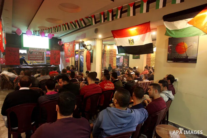 Palestinian fans watch the CAF Champions League second leg final football match between Egypt's Al-Ahly and Tunisia's ES Tunis which held on the Olympic stadium in Rades on a screen, in Gaza City on November 9, 2018. Pho...