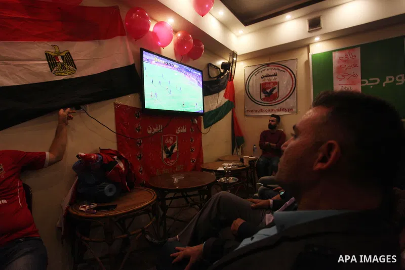 Palestinian fans watch the CAF Champions League second leg final football match between Egypt's Al-Ahly and Tunisia's ES Tunis which held on the Olympic stadium in Rades on a screen, in Gaza City on November 9, 2018. Pho...