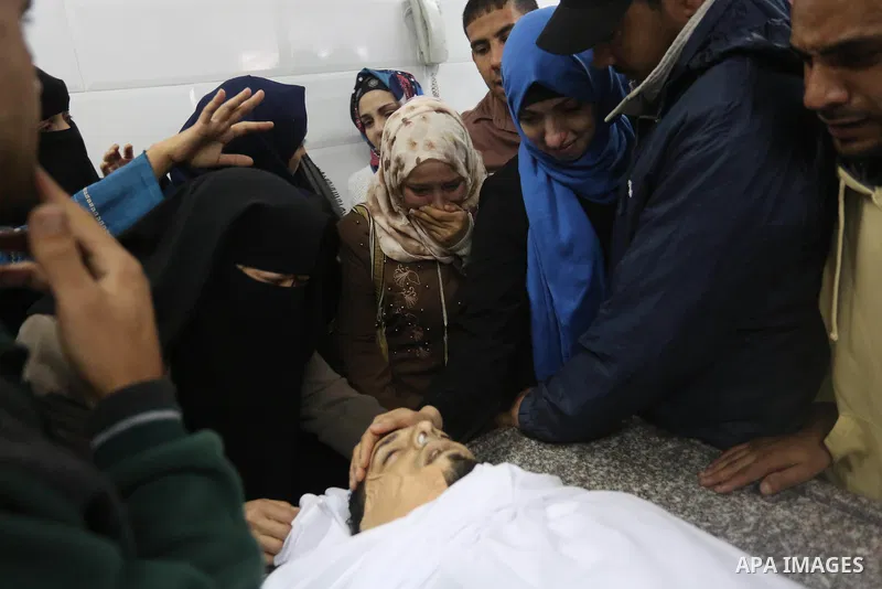 Relatives of Palestinian Rami Qahman, 28, who was shot dead by Israeli forces at the Israel-Gaza border, mourn over his body during his funeral at the morgue of the European Hospital in Khan Yunis in the southern Gaza St...