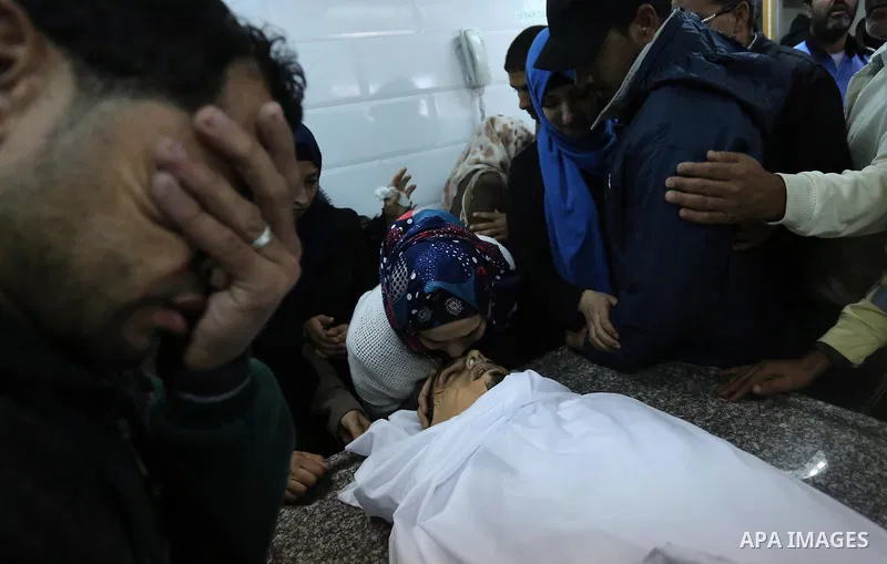 Relatives of Palestinian Rami Qahman, 28, who was shot dead by Israeli forces at the Israel-Gaza border, mourn over his body during his funeral at the morgue of the European Hospital in Khan Yunis in the southern Gaza St...