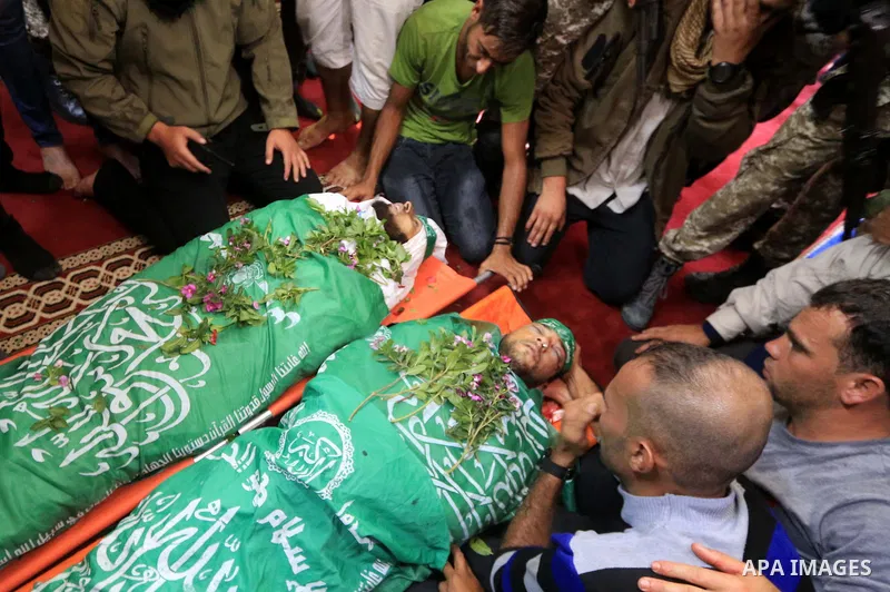 Relatives of Mustafa Abu Odeh and Mahmoud Atallah, two of the seven Palestinians killed during an Israeli special forces operation in the Gaza Strip, morun over their bodies during their funeral, in Khan Younis in the so...
