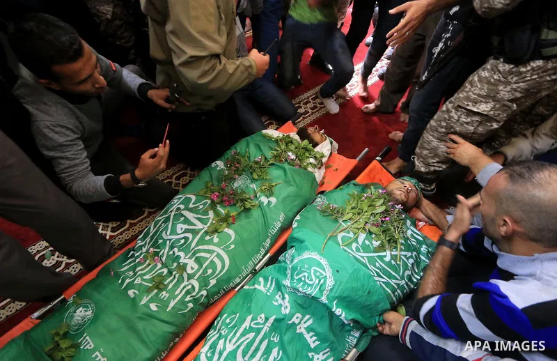 Relatives of Mustafa Abu Odeh and Mahmoud Atallah, two of the seven Palestinians killed during an Israeli special forces operation in the Gaza Strip, morun over their bodies during their funeral, in Khan Younis in the so...