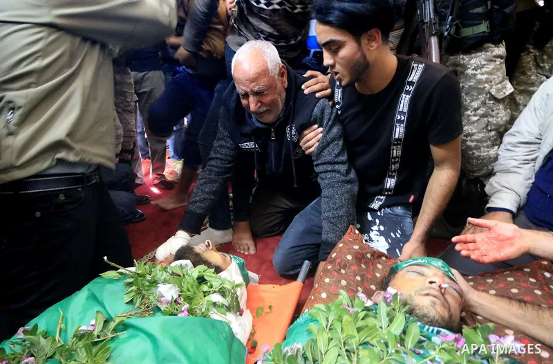 Relatives of Mustafa Abu Odeh and Mahmoud Atallah, two of the seven Palestinians killed during an Israeli special forces operation in the Gaza Strip, morun over their bodies during their funeral, in Khan Younis in the so...