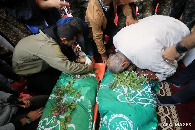 Relatives of Mustafa Abu Odeh and Mahmoud Atallah, two of the seven Palestinians killed during an Israeli special forces operation in the Gaza Strip, morun over their bodies during their funeral, in Khan Younis in the so...