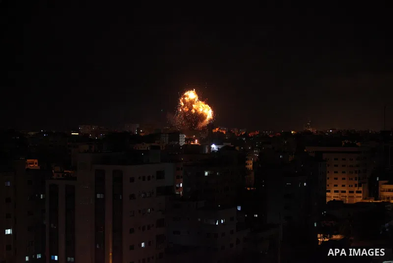 A picture taken on November 12, 2018, shows a ball of fire and smoke rise above the building housing the television station al-Aqsa TV during an Israeli air strike in Gaza City. Israel's military said it was carrying out...