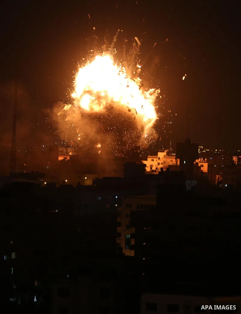 A picture taken on November 12, 2018, shows a ball of fire and smoke rise above the building housing the television station al-Aqsa TV during an Israeli air strike in Gaza City. Israel's military said it was carrying out...