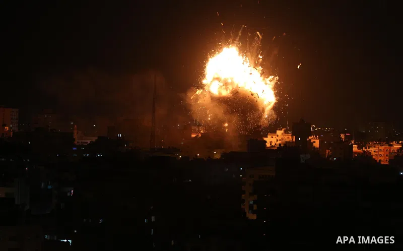 A picture taken on November 12, 2018, shows a ball of fire and smoke rise above the building housing the television station al-Aqsa TV during an Israeli air strike in Gaza City. Israel's military said it was carrying out...