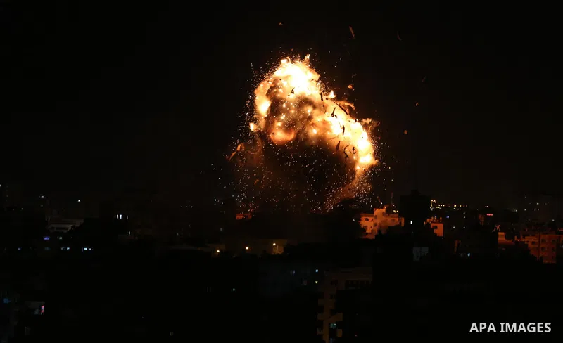 A picture taken on November 12, 2018, shows a ball of fire and smoke rise above the building housing the television station al-Aqsa TV during an Israeli air strike in Gaza City. Israel's military said it was carrying out...