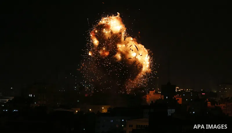A picture taken on November 12, 2018, shows a ball of fire and smoke rise above the building housing the television station al-Aqsa TV during an Israeli air strike in Gaza City. Israel's military said it was carrying out...