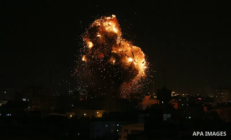 A picture taken on November 12, 2018, shows a ball of fire and smoke rise above the building housing the television station al-Aqsa TV during an Israeli air strike in Gaza City. Israel's military said it was carrying out...