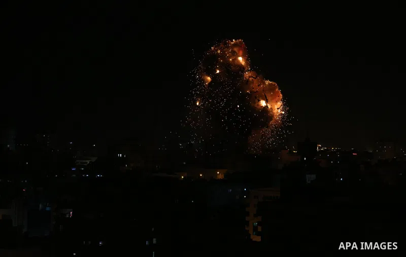 A picture taken on November 12, 2018, shows a ball of fire and smoke rise above the building housing the television station al-Aqsa TV during an Israeli air strike in Gaza City. Israel's military said it was carrying out...