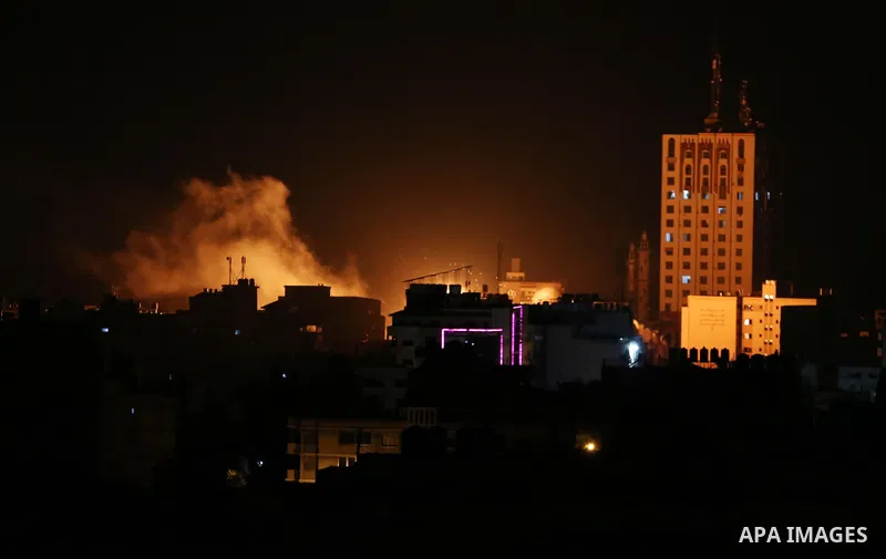 A picture taken on November 12, 2018, shows a ball of fire and smoke rise above the building housing the television station al-Aqsa TV during an Israeli air strike in Gaza City. Israel's military said it was carrying out...