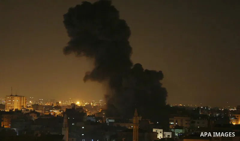 A picture taken on November 12, 2018, shows a ball of fire and smoke rise above the building housing the television station al-Aqsa TV during an Israeli air strike in Gaza City. Israel's military said it was carrying out...