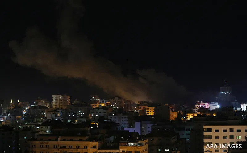 A picture taken on November 12, 2018, shows a ball of fire and smoke rise above the building housing the television station al-Aqsa TV during an Israeli air strike in Gaza City. Israel's military said it was carrying out...