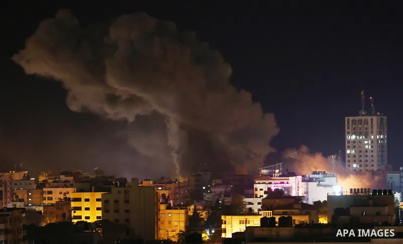 A picture taken on November 12, 2018, shows a ball of fire and smoke rise above the building housing the television station al-Aqsa TV during an Israeli air strike in Gaza City. Israel's military said it was carrying out...