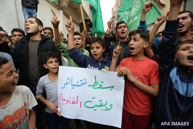 Palestinian protesters take part during a demonstration as they celebrate after Israeli Defence Minister Avigdor Lieberman announced his resignation outside the house of Chairman of the political bureau of the Hamas Pale...