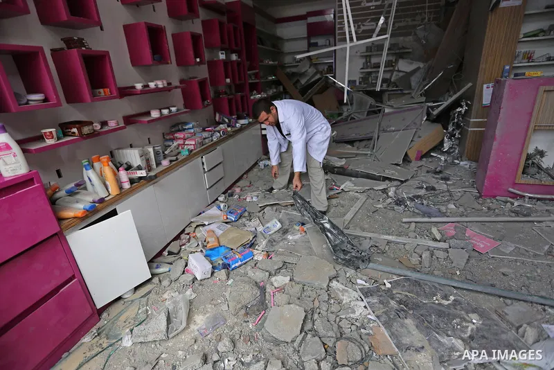 A Palestinian Doctor inspects the rubble of pharmacy destroyed by Israeli air strikes in Gaza City on November 15, 2018. Photo by Ashraf Amra