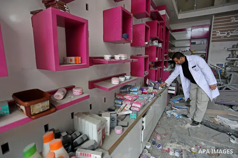 A Palestinian Doctor inspects the rubble of pharmacy destroyed by Israeli air strikes in Gaza City on November 15, 2018. Photo by Ashraf Amra