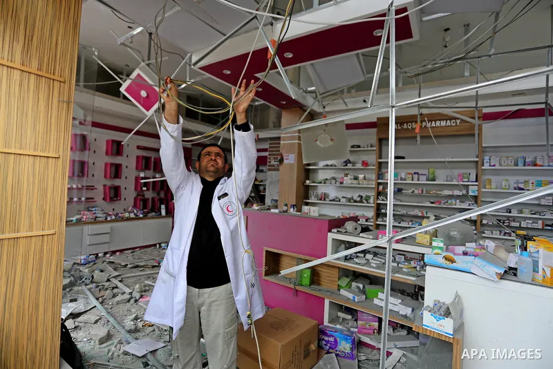 A Palestinian Doctor inspects the rubble of pharmacy destroyed by Israeli air strikes in Gaza City on November 15, 2018. Photo by Ashraf Amra
