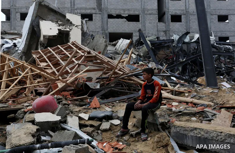 Palestinians inspect the rubble of the television station al-Aqsa TV destroyed by Israeli air strikes in Gaza City on November 15, 2018. Photo by Ashraf Amra