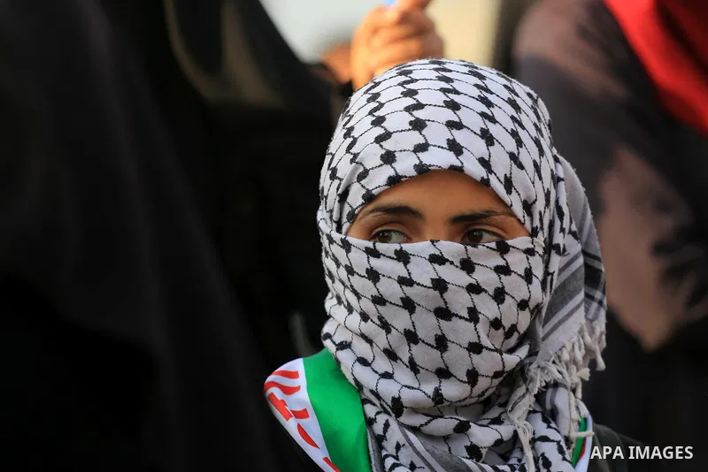 Palestinian protesters gather during clashes with Israeli troops in tents protest where Palestinians demand the right to return to their homeland at the Israel-Gaza border, in al-Bureij in the center of Gaza Strip on Nov...