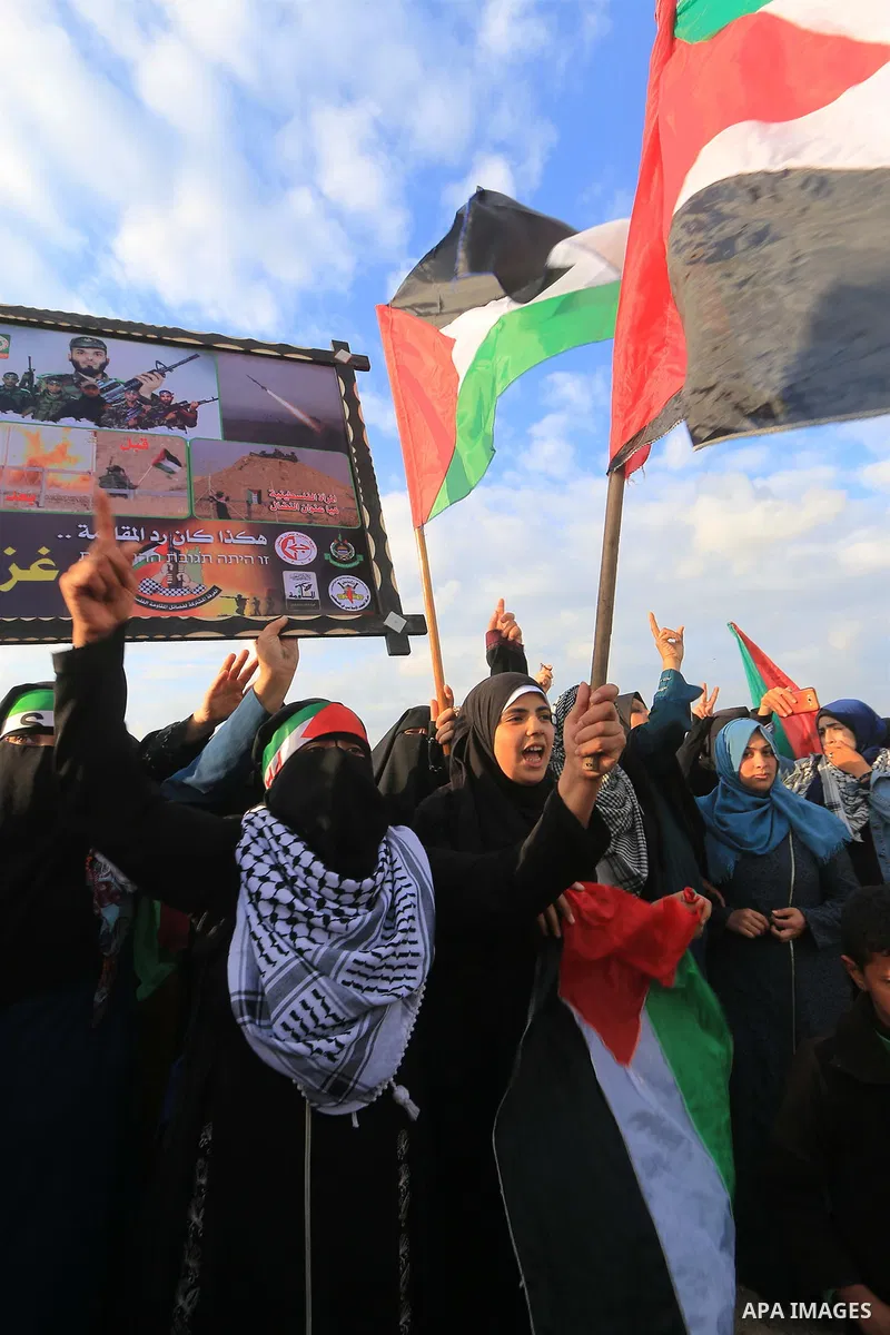 Palestinian protesters gather during clashes with Israeli troops in tents protest where Palestinians demand the right to return to their homeland at the Israel-Gaza border, in al-Bureij in the center of Gaza Strip on Nov...