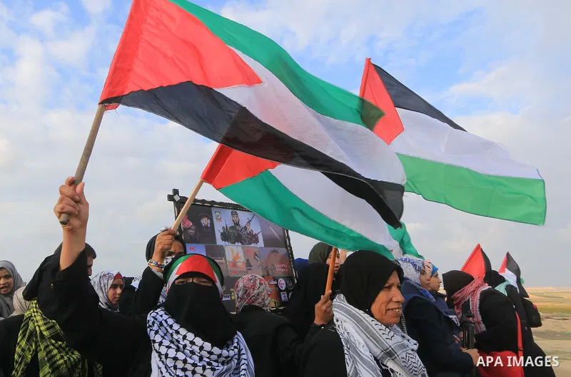 Palestinian protesters gather during clashes with Israeli troops in tents protest where Palestinians demand the right to return to their homeland at the Israel-Gaza border, in al-Bureij in the center of Gaza Strip on Nov...