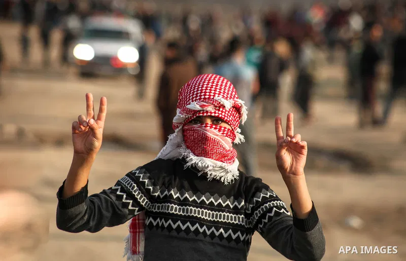 Palestinian protesters gather during clashes with Israeli troops in tents protest where Palestinians demand the right to return to their homeland at the Israel-Gaza border, in Jabalia in the northern Gaza Strip on Novemb...