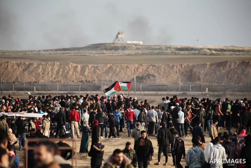 Palestinian protesters gather during clashes with Israeli troops in tents protest where Palestinians demand the right to return to their homeland at the Israel-Gaza border, in Jabalia in the northern Gaza Strip on Novemb...