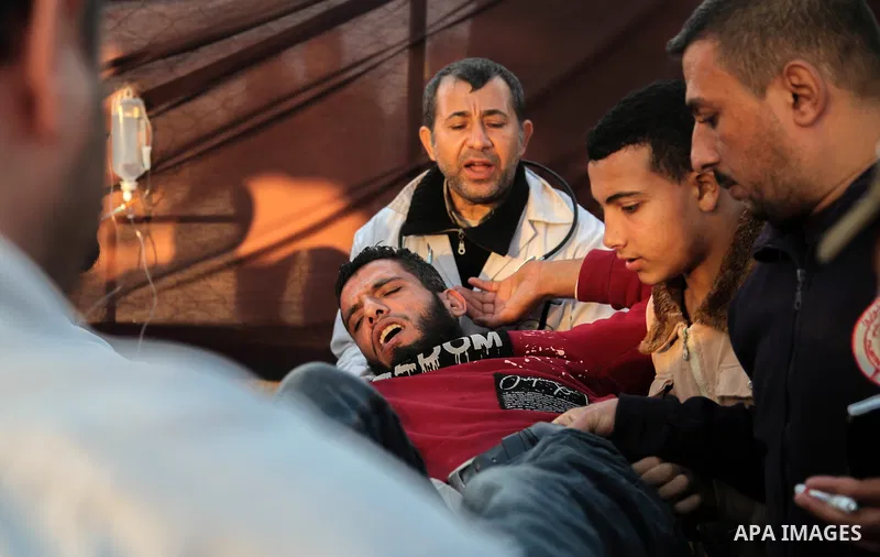A Palestinian protester who was wounded during clashes with Israeli forces in tents protest where Palestinians demand the right to return to their homeland at the Israel-Gaza border, recives treatment in Jabalia in the n...