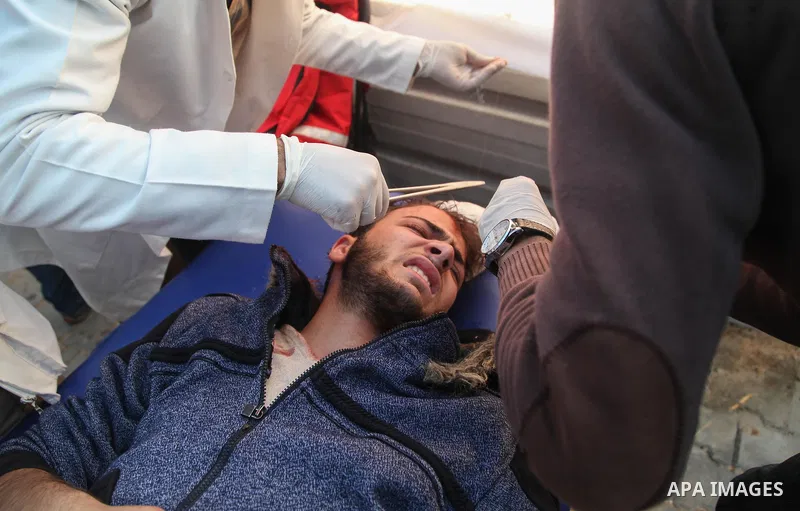 A Palestinian protester who was wounded during clashes with Israeli forces in tents protest where Palestinians demand the right to return to their homeland at the Israel-Gaza border, recives treatment in Jabalia in the n...