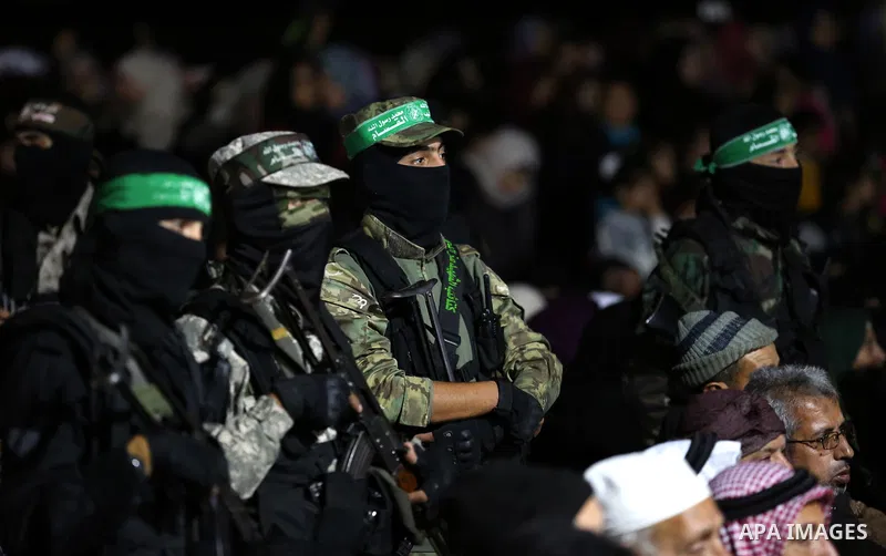 Members of Ezzedine al-Qassam Brigades, the armed wing of the Palestinian Hamas movement attend a memorial service for seven of their colleagues who were killed during an Israeli special forces operation in the Gaza Stri...