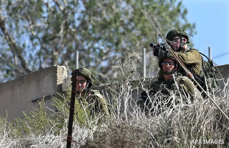 Israeli forces take position during clashes with Palestinian protesters after prevent Palestinian farmers to reach to their lands and planting olive trees, in the West Bank village of Urif, near Nablus on November 17, 20...