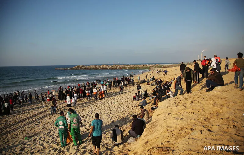 Palestinian protesters gather during clashes with Israeli forces in a demonstration against the Israeli blockade on Gaza Strip, along the Gaza sea barrier on the maritime border with Israel near Kibbutz Zikim, north of B...