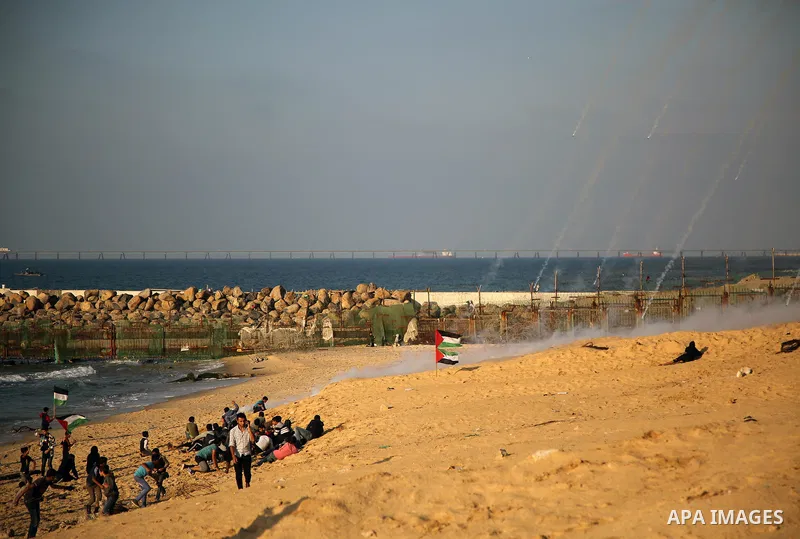 Palestinian protesters gather during clashes with Israeli forces in a demonstration against the Israeli blockade on Gaza Strip, along the Gaza sea barrier on the maritime border with Israel near Kibbutz Zikim, north of B...