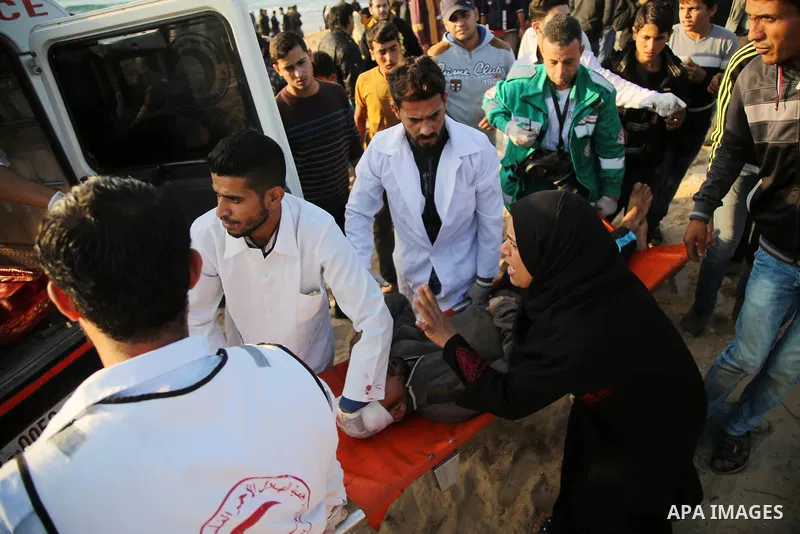 A wounded Palestinian protester is evacuated during clashes with Israeli forces in a demonstration against the Israeli blockade on Gaza Strip, along the Gaza sea barrier on the maritime border with Israel near Kibbutz Zi...