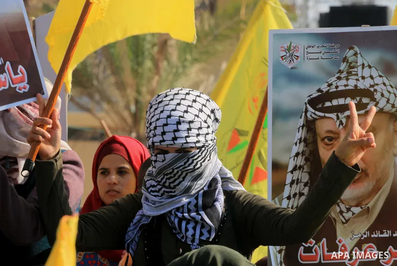 Palestinian Fatah supporters take part in a rally to mark the 14th anniversary of the death of late Palestinian leader Yasser Arafat in Gaza City on November 20, 2018. Photo by Mahmoud Khattab