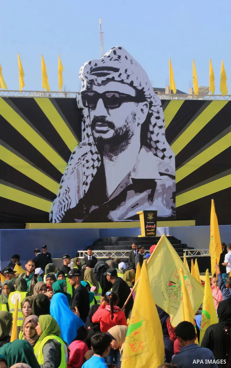 Palestinian Fatah supporters take part in a rally to mark the 14th anniversary of the death of late Palestinian leader Yasser Arafat in Gaza City on November 20, 2018. Photo by Mahmoud Khattab