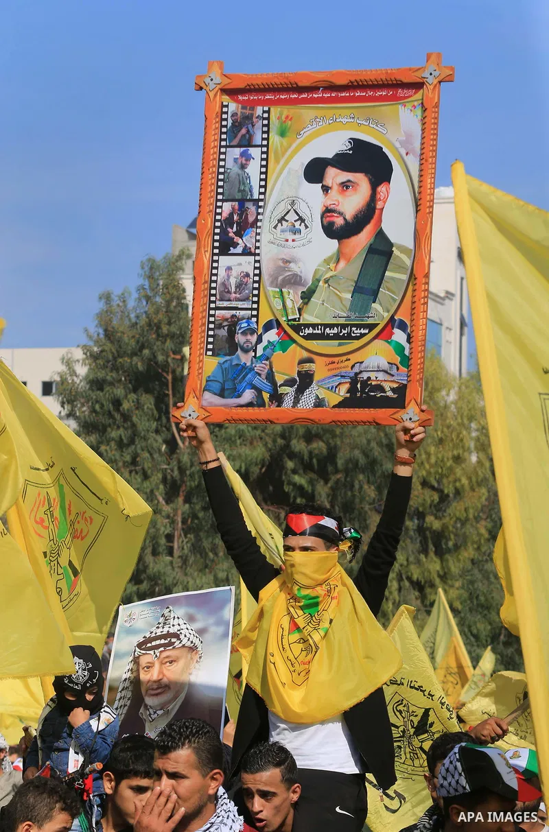 Palestinian Fatah supporters take part in a rally to mark the 14th anniversary of the death of late Palestinian leader Yasser Arafat in Gaza City on November 20, 2018. Photo by Mahmoud Khattab